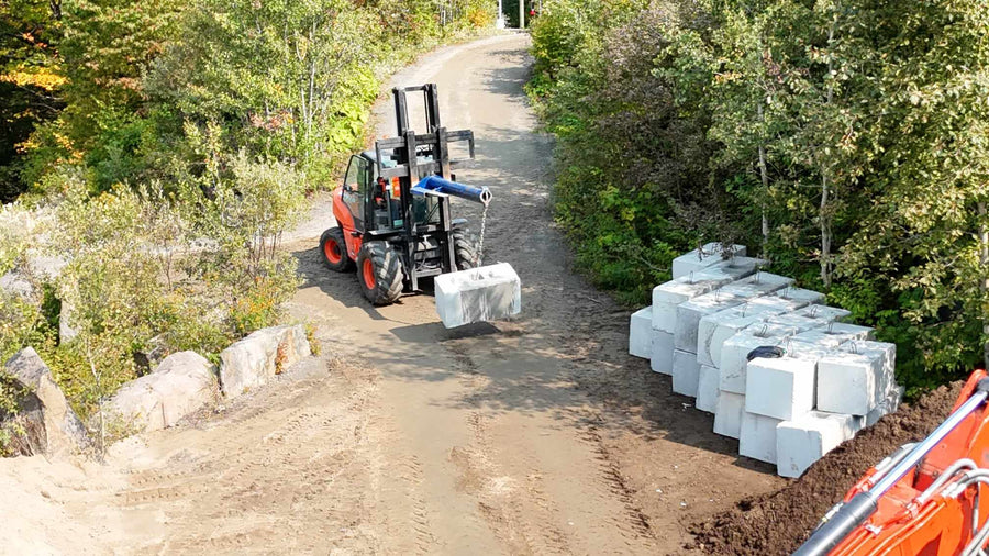 Pose de blocs de béton lego au chariot élévateur tout-terrain